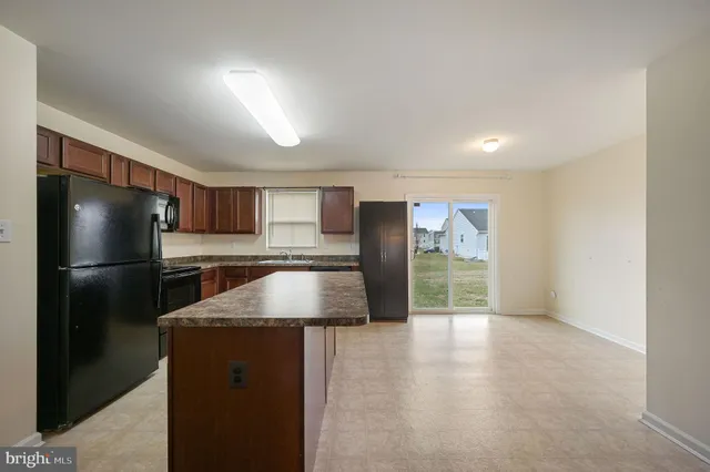 a view of a kitchen with a sink and a refrigerator