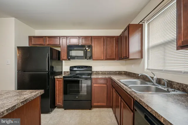 a kitchen with a sink a stove and refrigerator