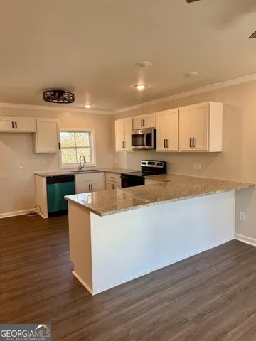 a kitchen with stainless steel appliances a stove top oven and a sink