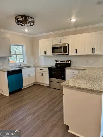 a kitchen with stainless steel appliances granite countertop a stove sink and cabinets