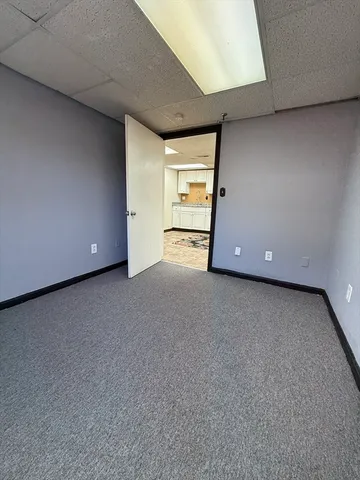 a view of a livingroom with an empty space and a window