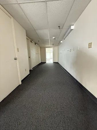 a view of a livingroom with a ceiling fan and window