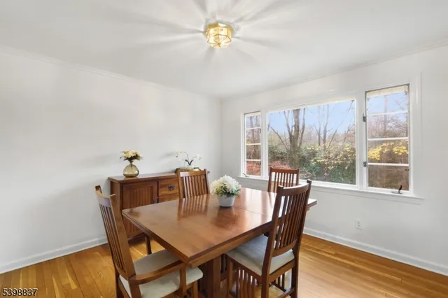 a kitchen with granite countertop a refrigerator a stove a sink and white cabinets