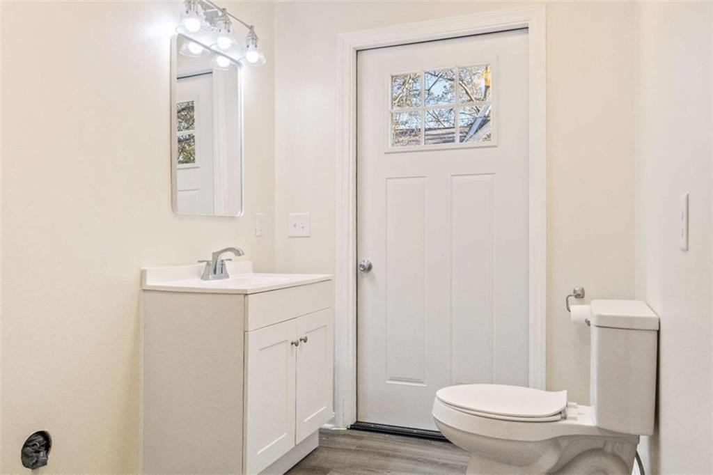 614 Burnett Ferry Road Southwest Rome, GA 30165 - Photo 16 of 29 a bathroom with a toilet sink and mirror