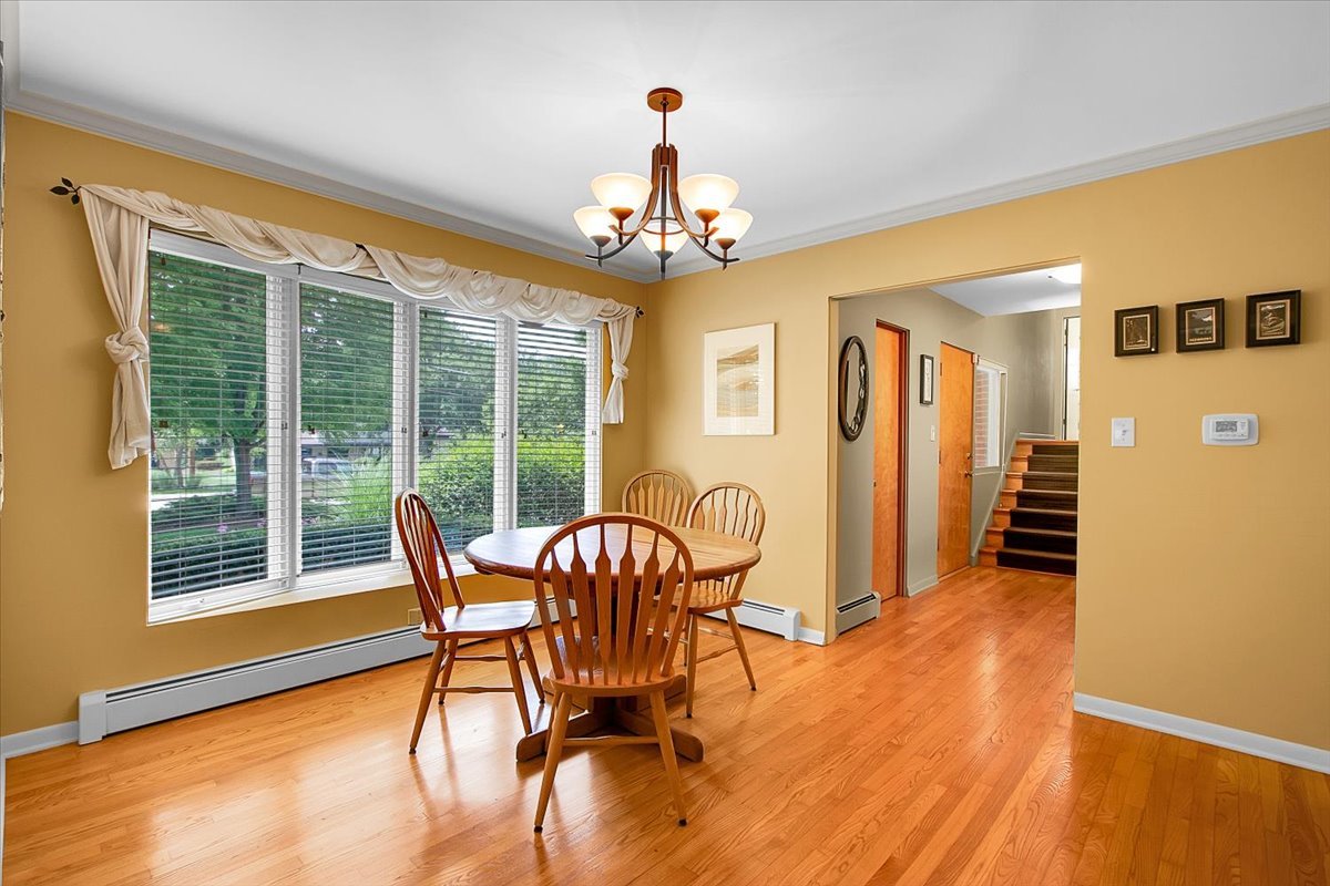 443 Lombard Road Itasca, IL 60143 - Photo 11 of 43 a dining room with furniture a chandelier and wooden floor