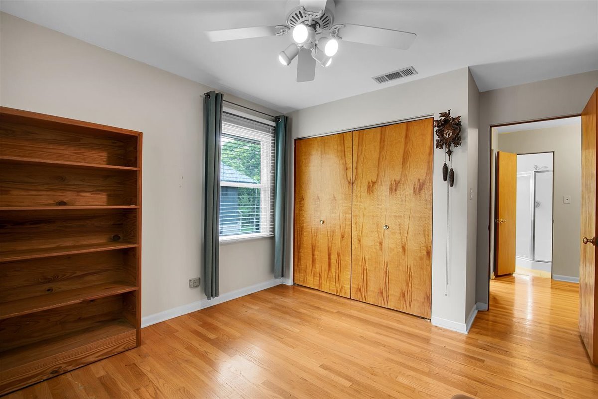 443 Lombard Road Itasca, IL 60143 - Photo 22 of 43 a view of empty room with wooden floor and fan