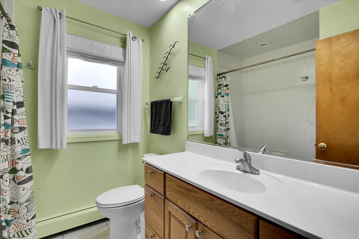 443 Lombard Road Itasca, IL 60143 - Photo 25 of 43 a bathroom with a sink a toilet and mirror