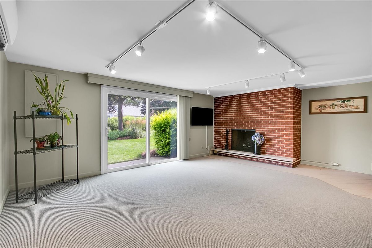 443 Lombard Road Itasca, IL 60143 - Photo 27 of 43 a view of an empty room with a fireplace and a window