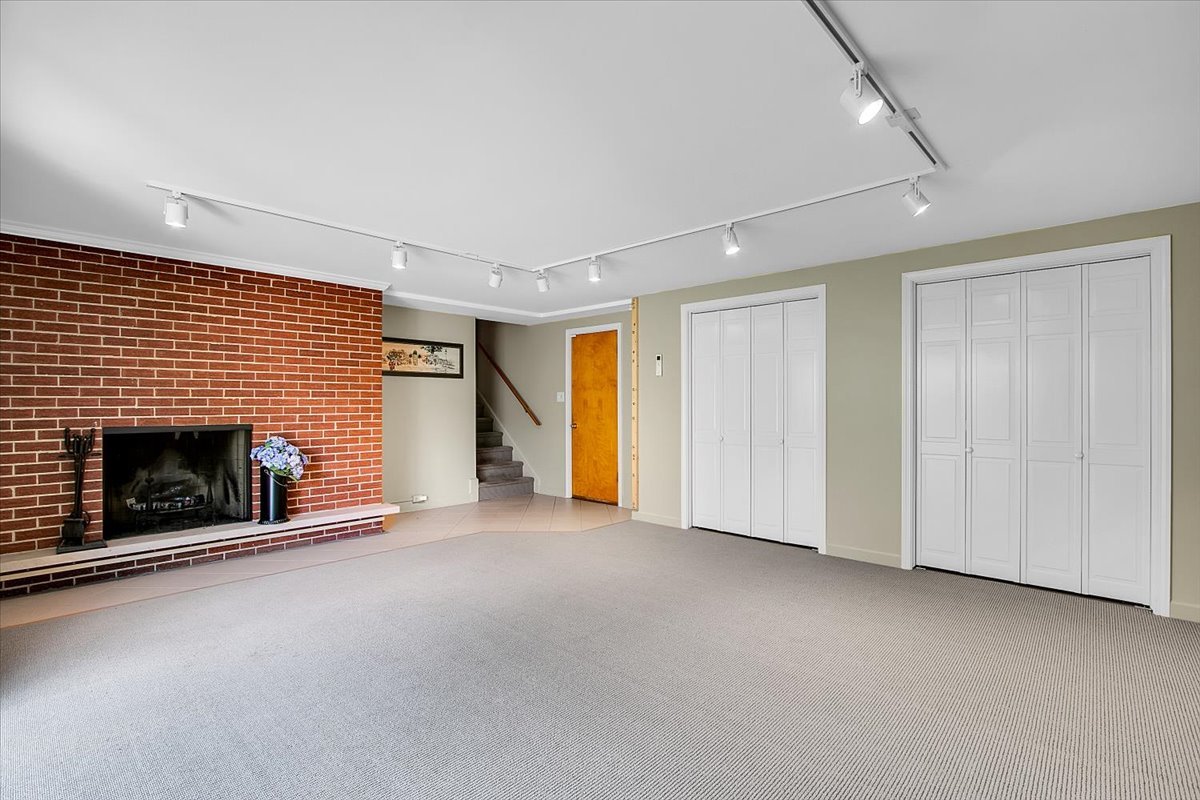 443 Lombard Road Itasca, IL 60143 - Photo 28 of 43 an empty room with a fireplace and window
