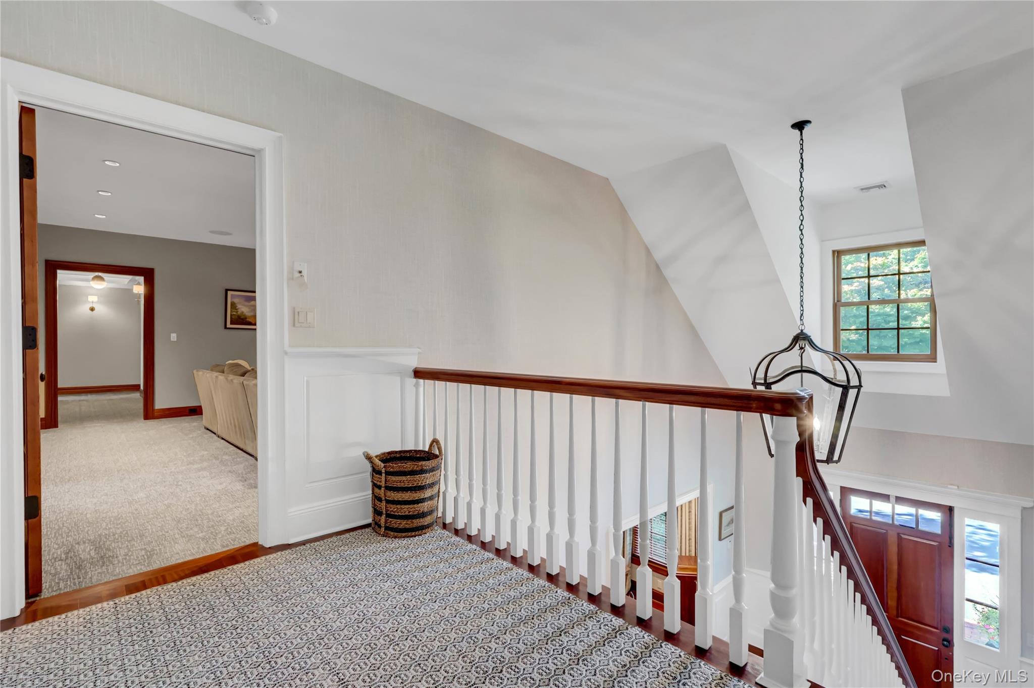 63 Dyke Road Setauket, NY 11733 - Photo 22 of 49 a view of a hallway with staircase and white walls