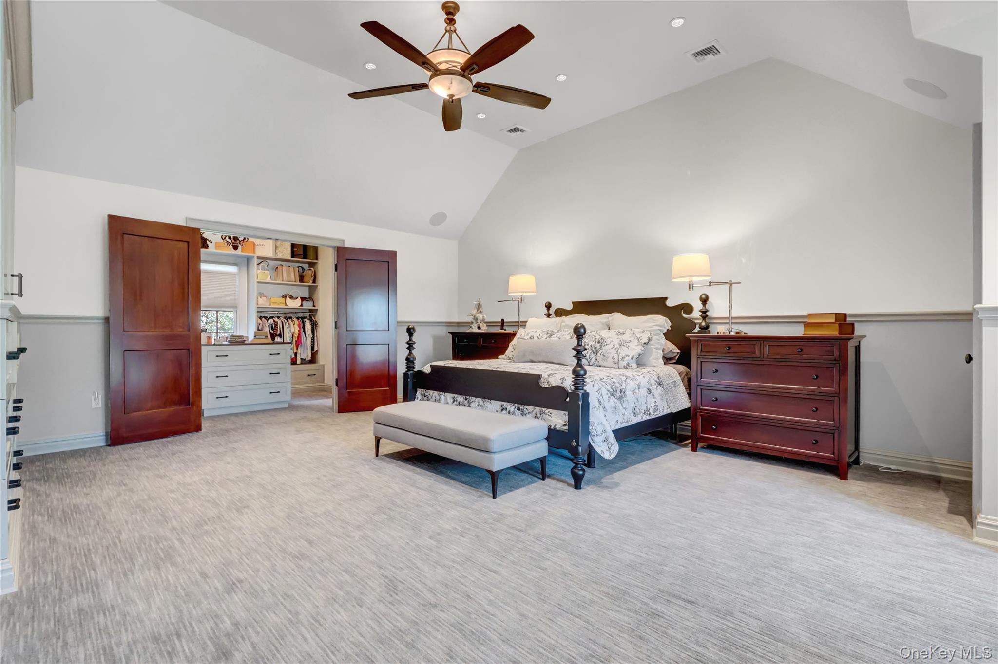 63 Dyke Road Setauket, NY 11733 - Photo 25 of 49 a spacious bedroom with a bed and ceiling fan