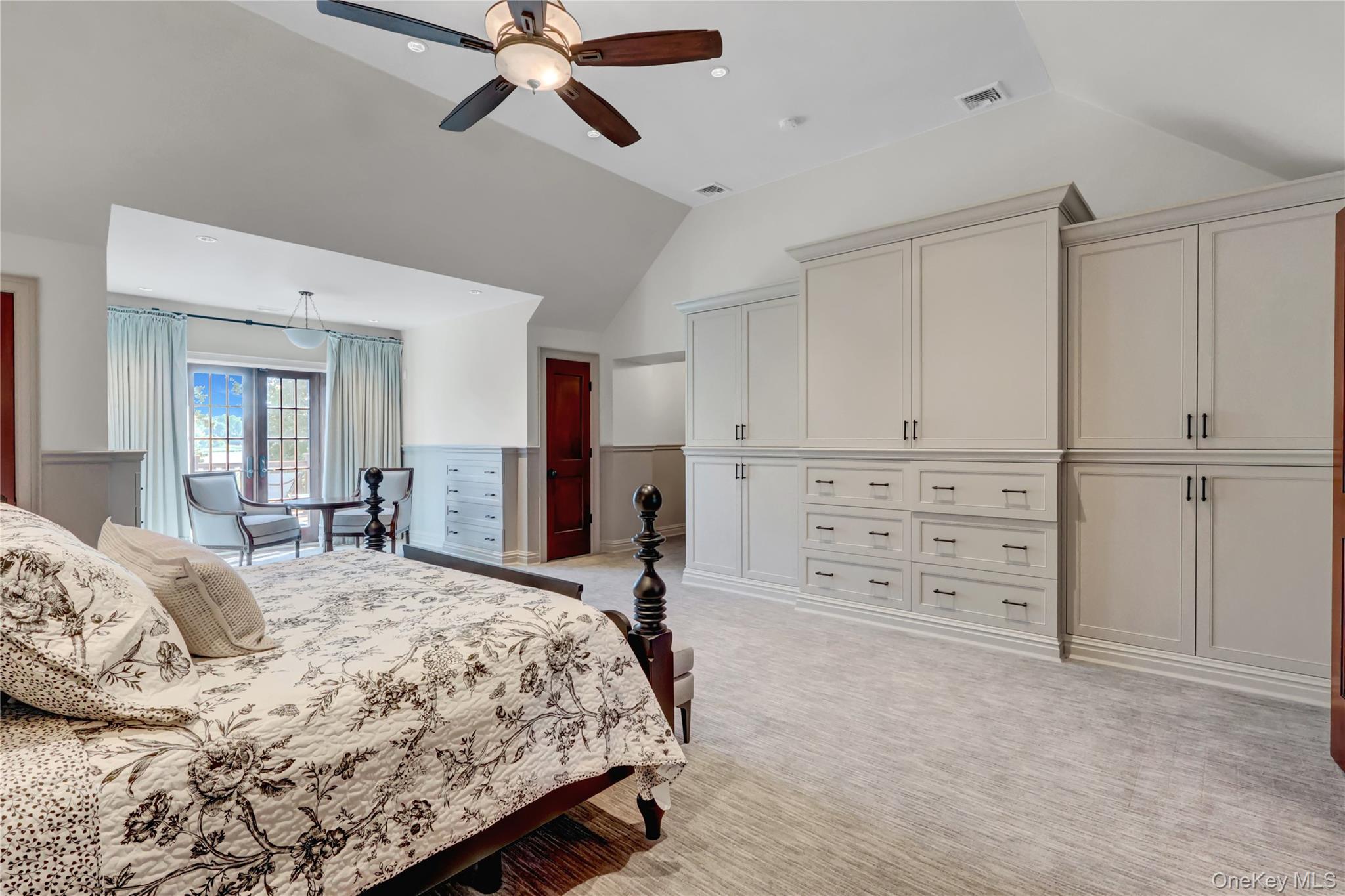 63 Dyke Road Setauket, NY 11733 - Photo 27 of 49 a bedroom with a bed and a chandelier