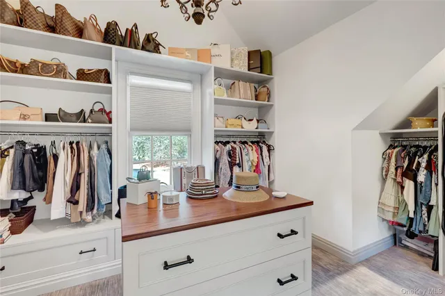 a living room with furniture a flat screen tv and a couch