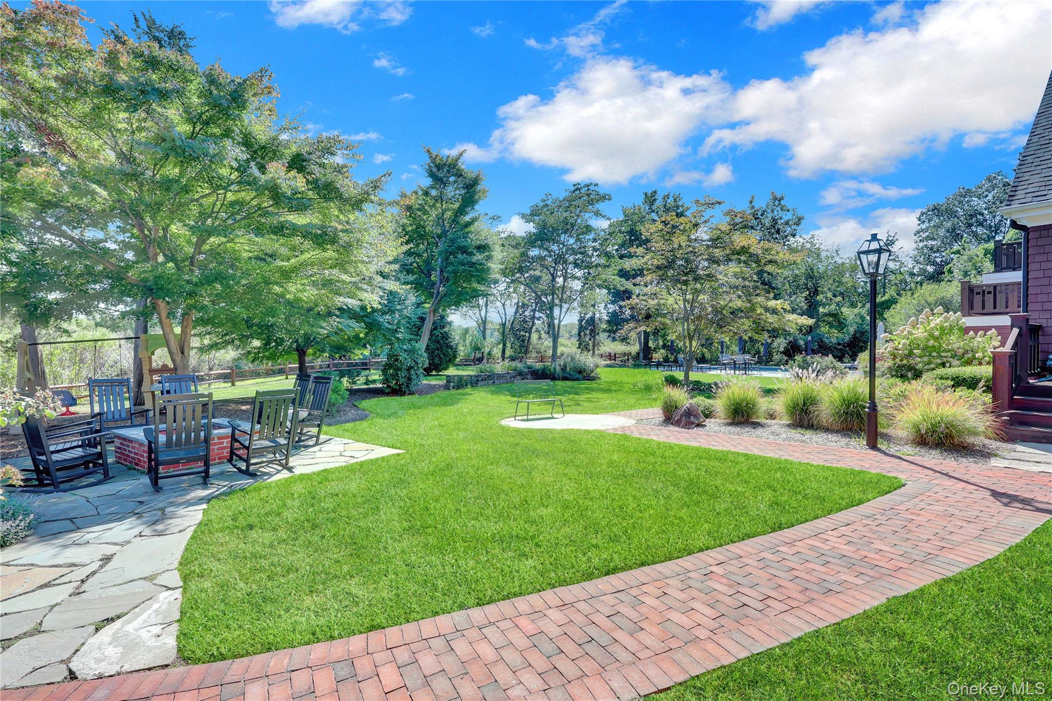 63 Dyke Road Setauket, NY 11733 - Photo 40 of 49 a view of a backyard with sitting area