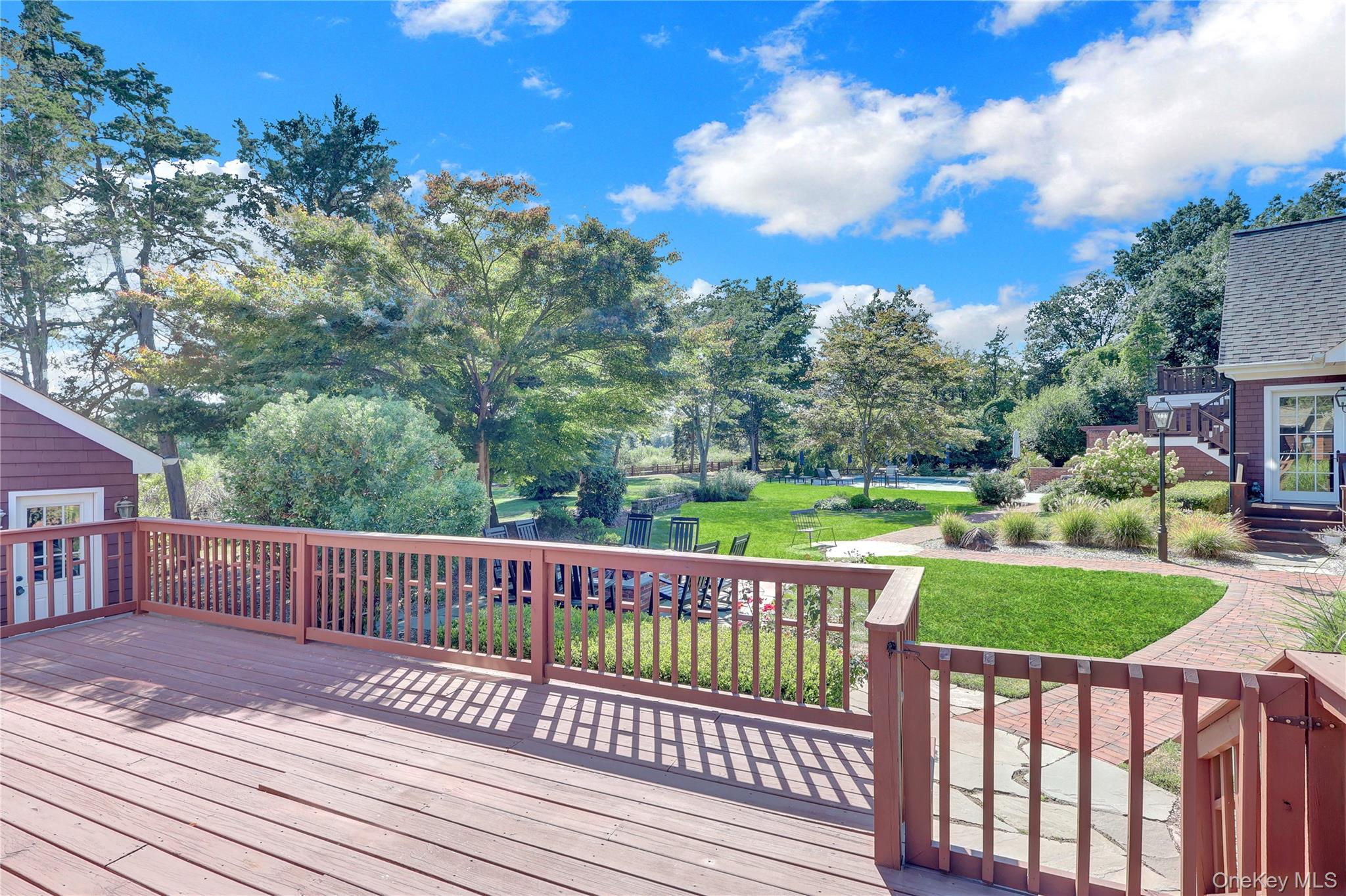 63 Dyke Road Setauket, NY 11733 - Photo 41 of 49 a view of a deck with a yard