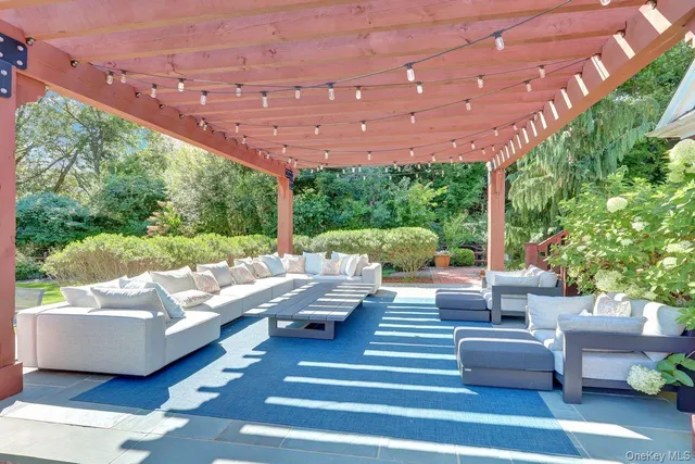 a view of a house with backyard and sitting area
