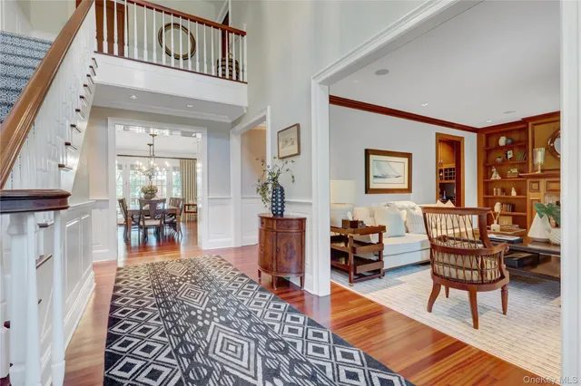 a dining room with furniture a rug a fireplace and wooden floor
