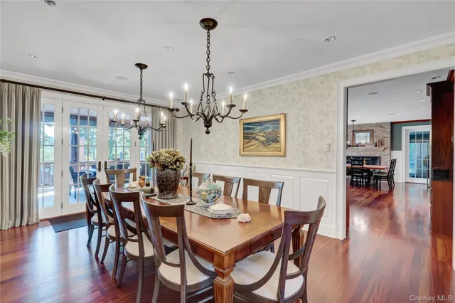 a view of a dining room with furniture wooden floor and chandelier