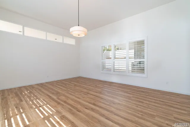 a view of a room with wooden floor and windows