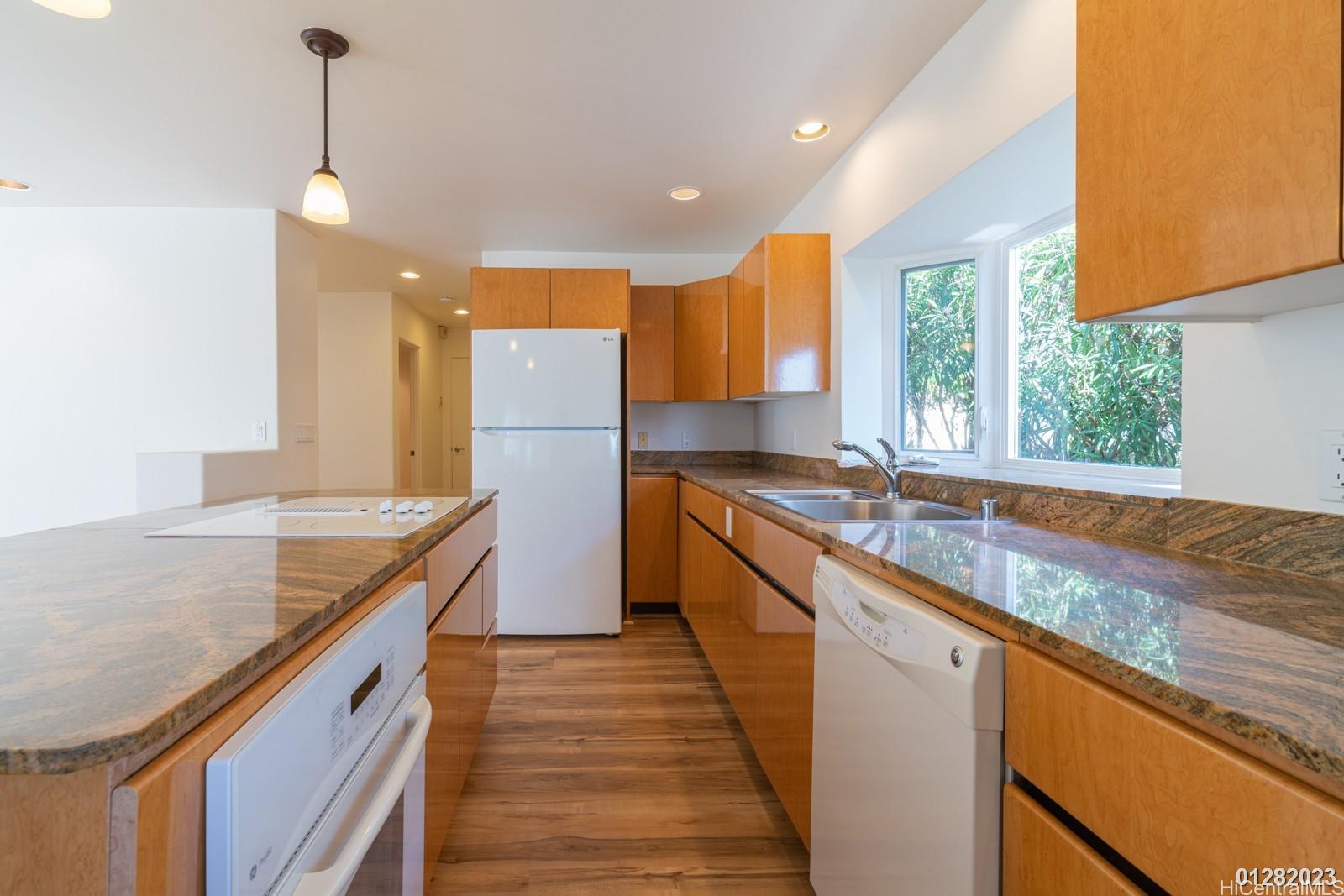 824 Ikena Circle Honolulu, HI 96821 - Photo 14 of 25 a kitchen with stainless steel appliances granite countertop a sink a stove and a wooden floors