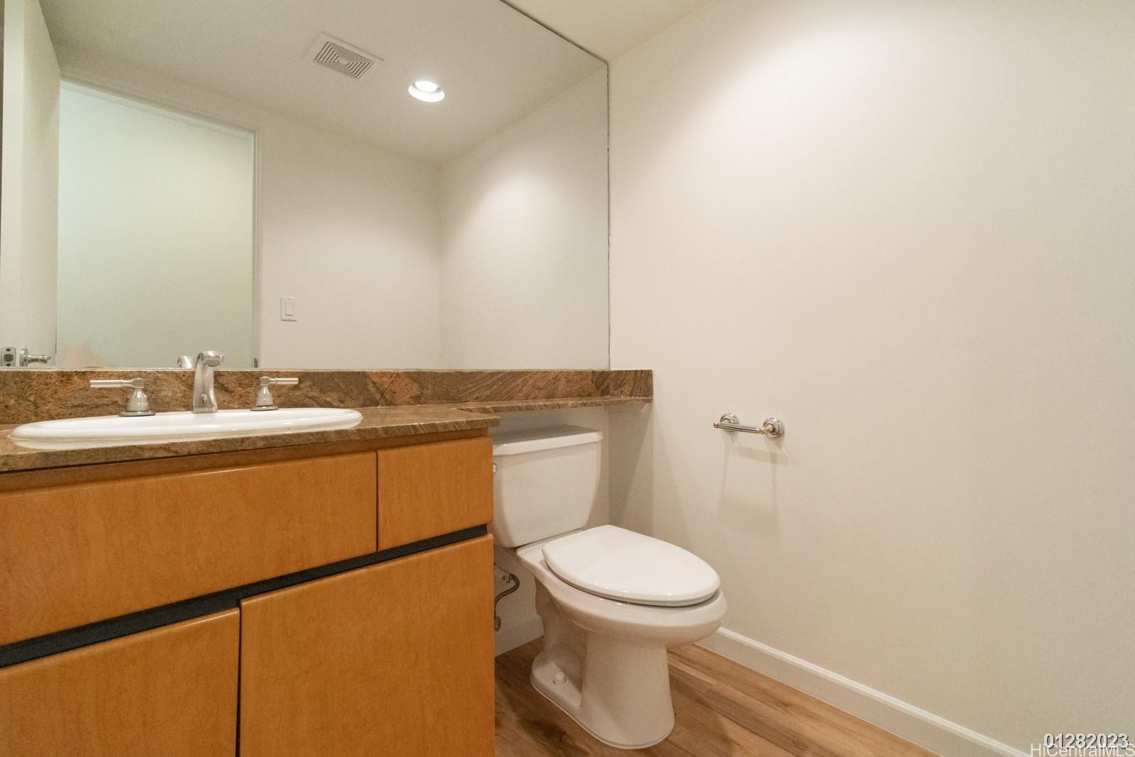 824 Ikena Circle Honolulu, HI 96821 - Photo 15 of 25 a bathroom with a toilet a sink and mirror