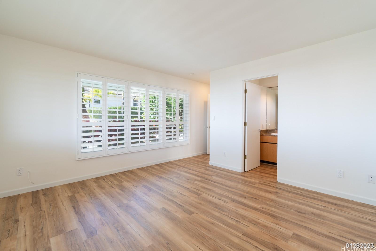 824 Ikena Circle Honolulu, HI 96821 - Photo 19 of 25 a view of an empty room with wooden floor and a window
