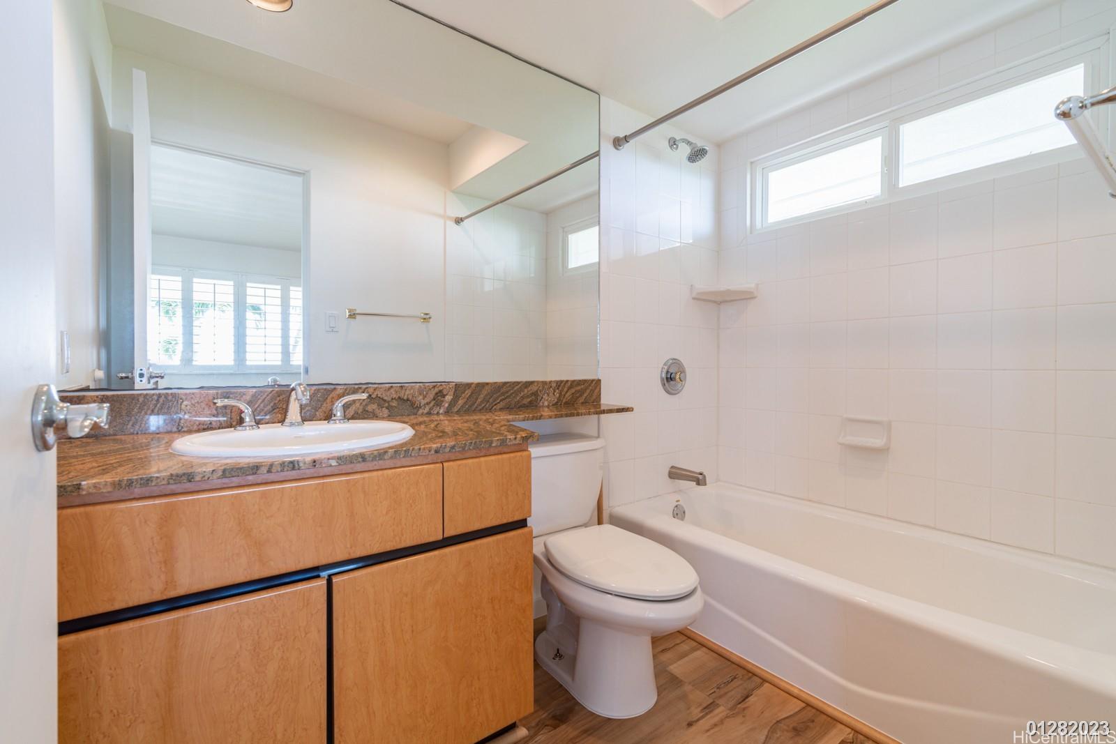 824 Ikena Circle Honolulu, HI 96821 - Photo 20 of 25 a bathroom with a granite countertop sink mirror vanity and toilet
