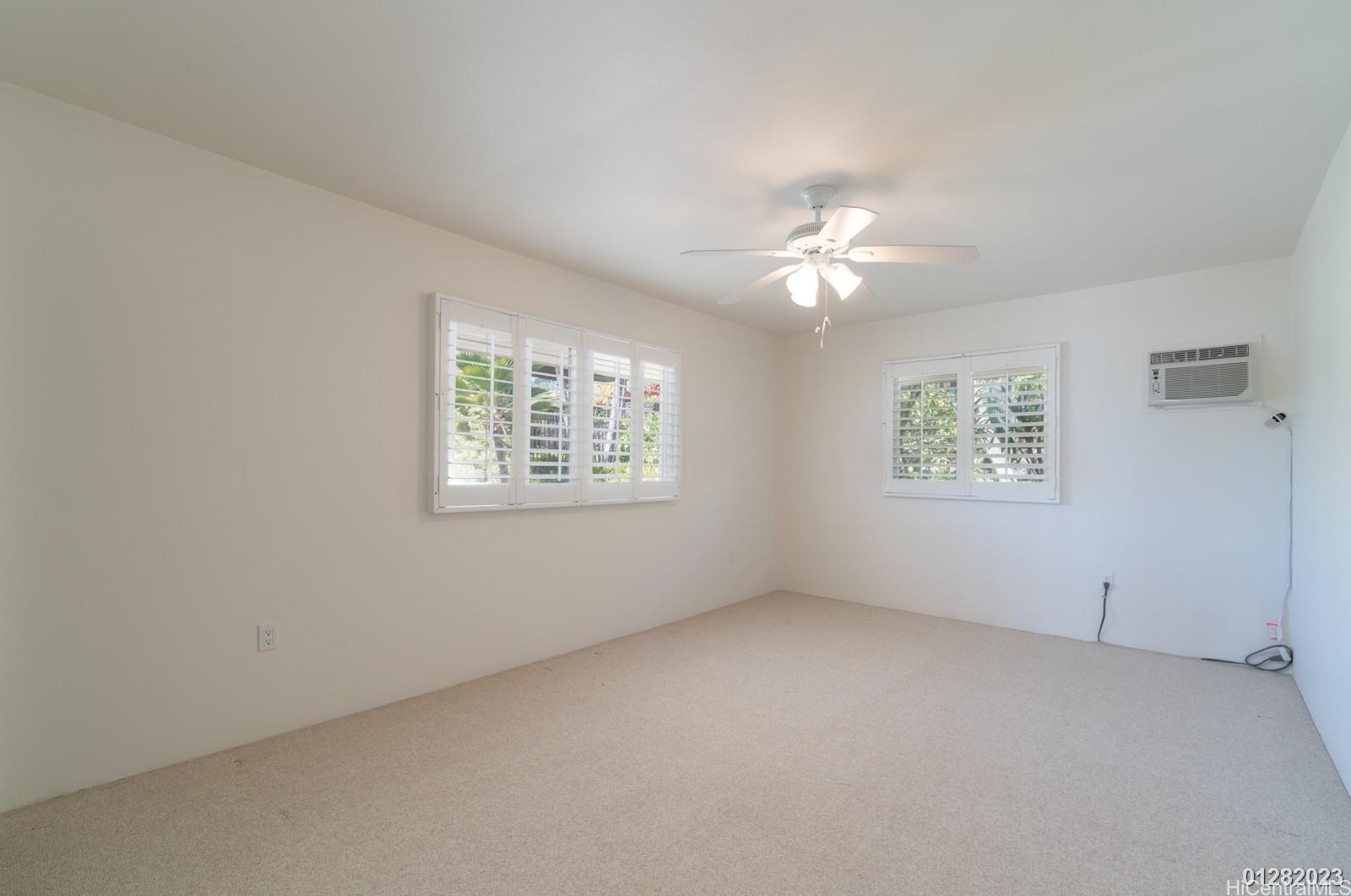 824 Ikena Circle Honolulu, HI 96821 - Photo 23 of 25 an empty room with a window and a ceiling fan