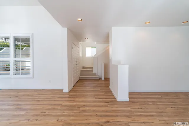 a view of a hallway with wooden floor