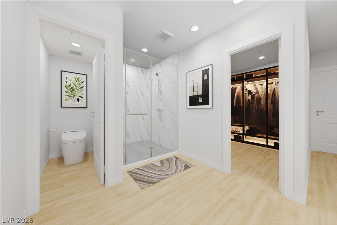 1140 Julie Road Henderson, NV 89002 - Photo 44 of 71 Virtually staged/remodeled. 1140 JULIE RD HENDERSON NV 89002. Blonde wood flooring unifies the bright bathroom, walk-in shower, and closet areas, offering seamless flow.