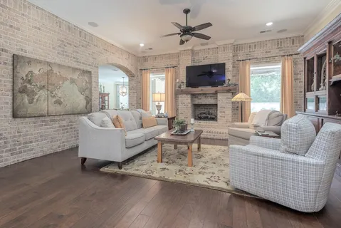 a living room with fireplace furniture and a flat screen tv
