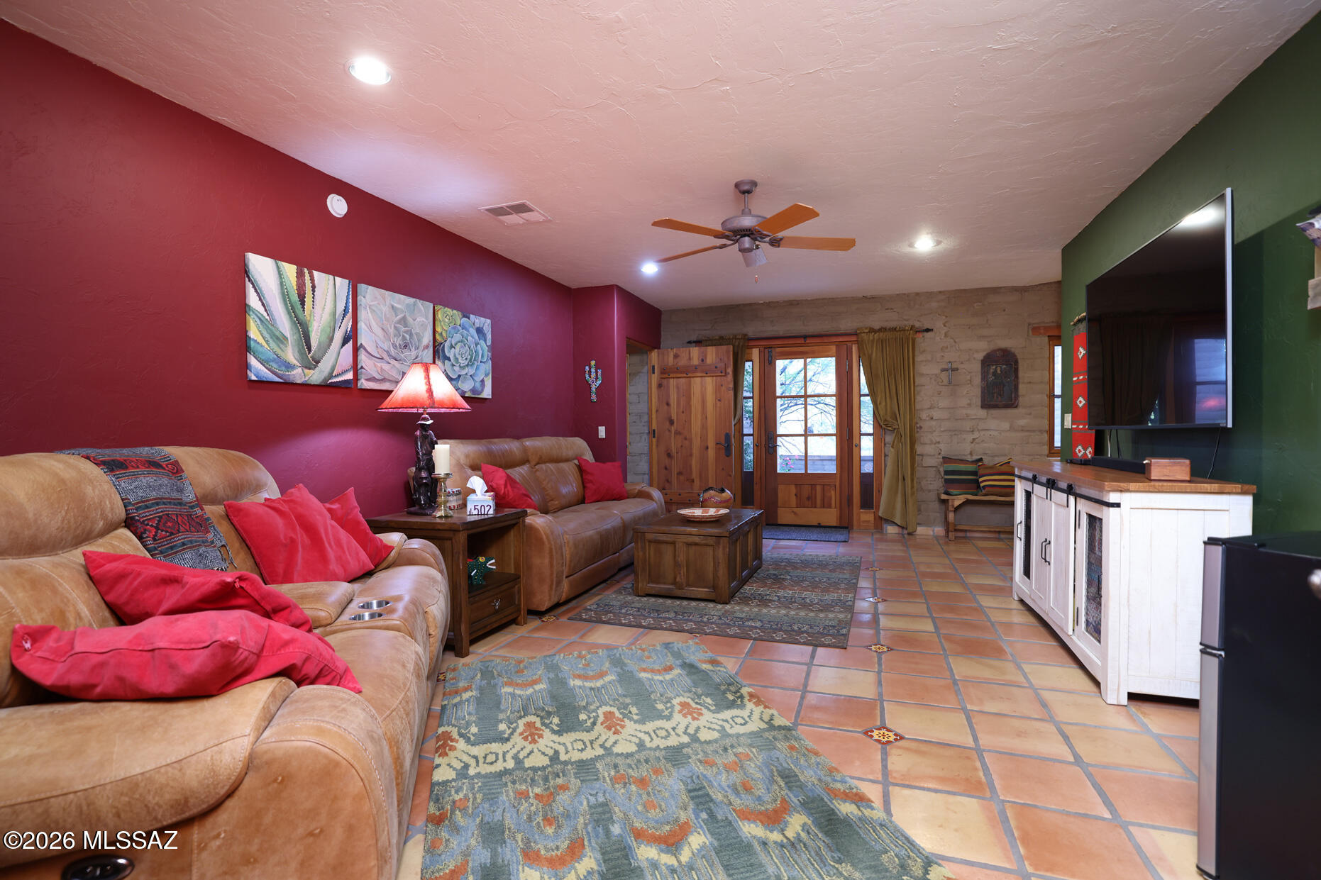 11725 East Spanish Ridge Place Tucson, AZ 85730 - Photo 30 of 51 a spacious bedroom with a bed and a couch