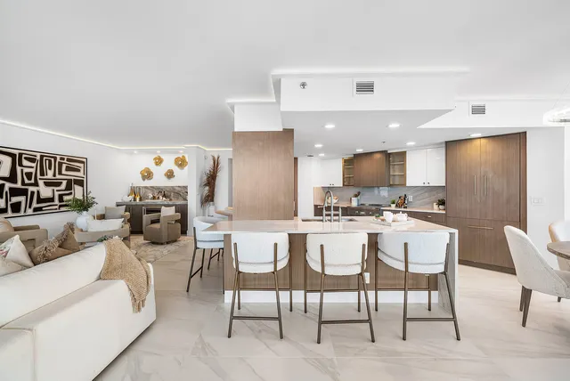 a living room with furniture and kitchen view