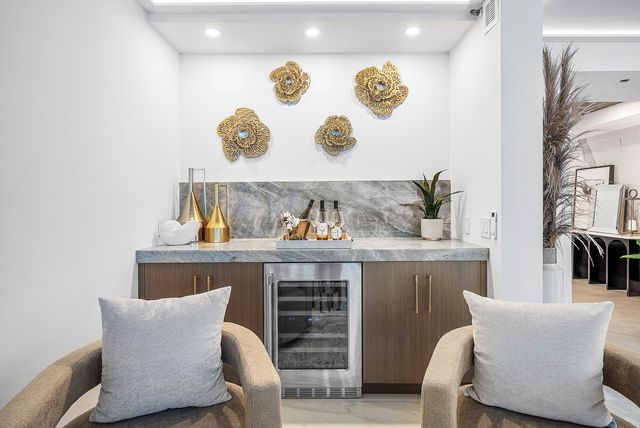 a living room with furniture and painting on the wall