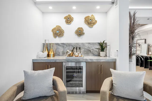 a living room with furniture and painting on the wall