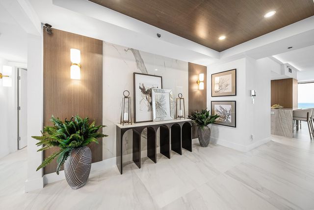 a view of entryway with livingroom and potted plant