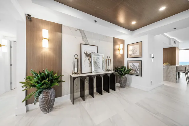 a view of entryway with livingroom and potted plant