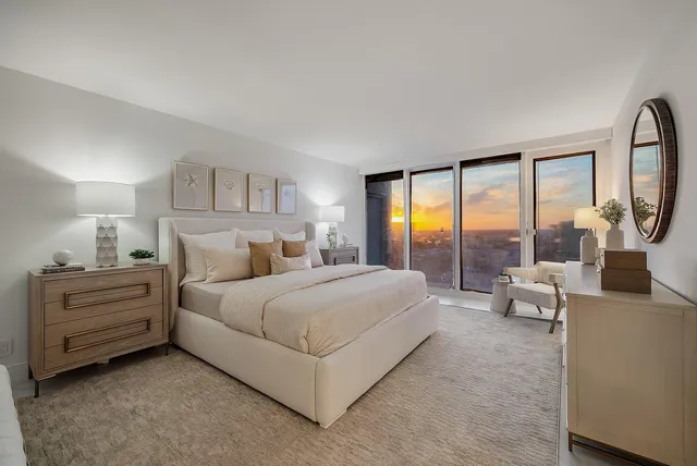 a spacious bedroom with a bed and a large window