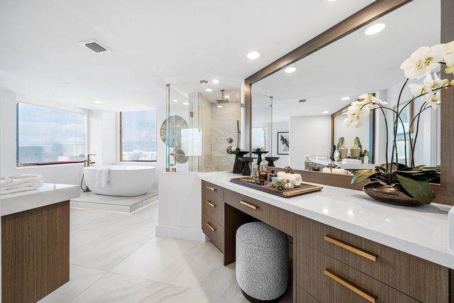 a kitchen with a sink a counter top space and living room view