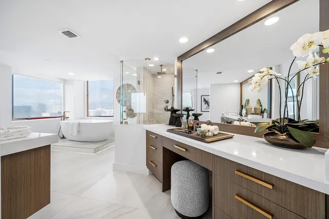 a kitchen with a sink a counter top space and living room view