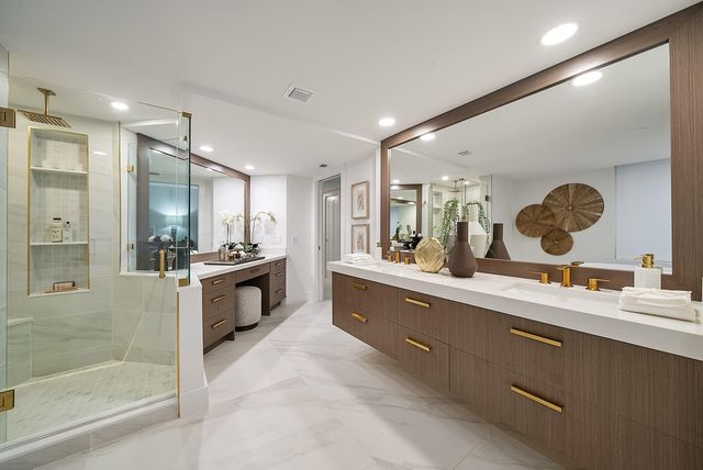 a large bathroom with a large mirror vanity and sink