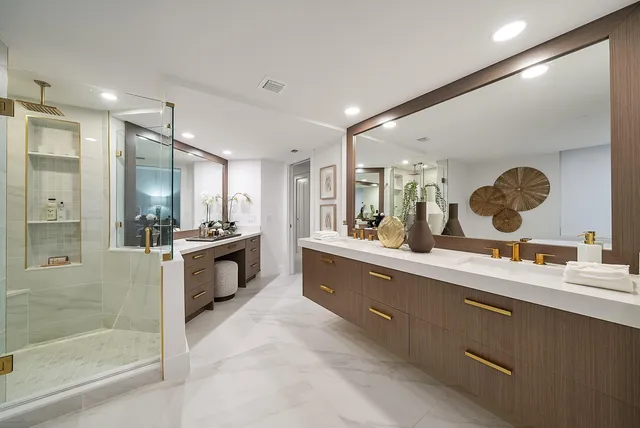 a large bathroom with a large mirror vanity and sink