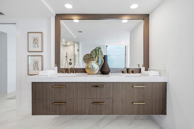 a bathroom with a sink vanity and mirror