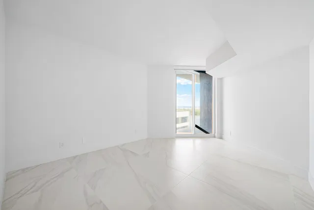 a bathroom with a toilet a sink a mirror a vanity and shower