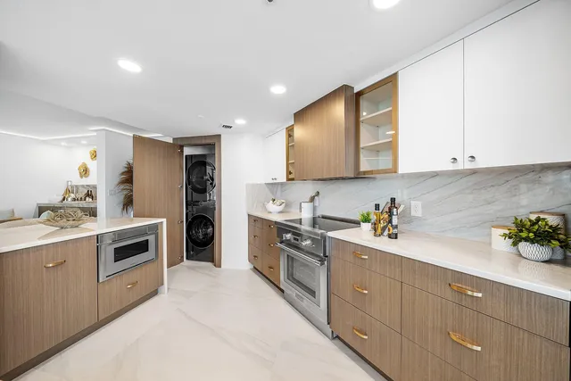 a kitchen with granite countertop white cabinets and white appliances