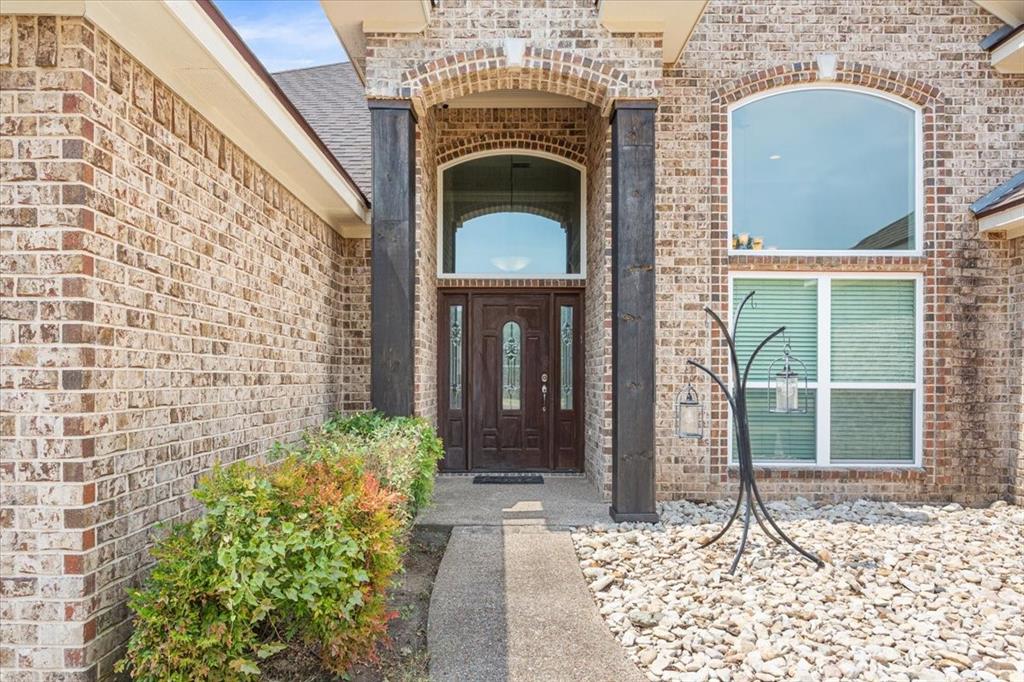 111 Spring Creek Street Waco, TX 76705 - Photo 5 of 40 Brick exterior with an arched entry and wood-finish columns
