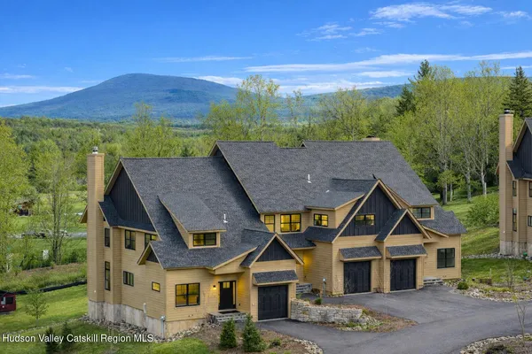 a aerial view of a house next to a yard