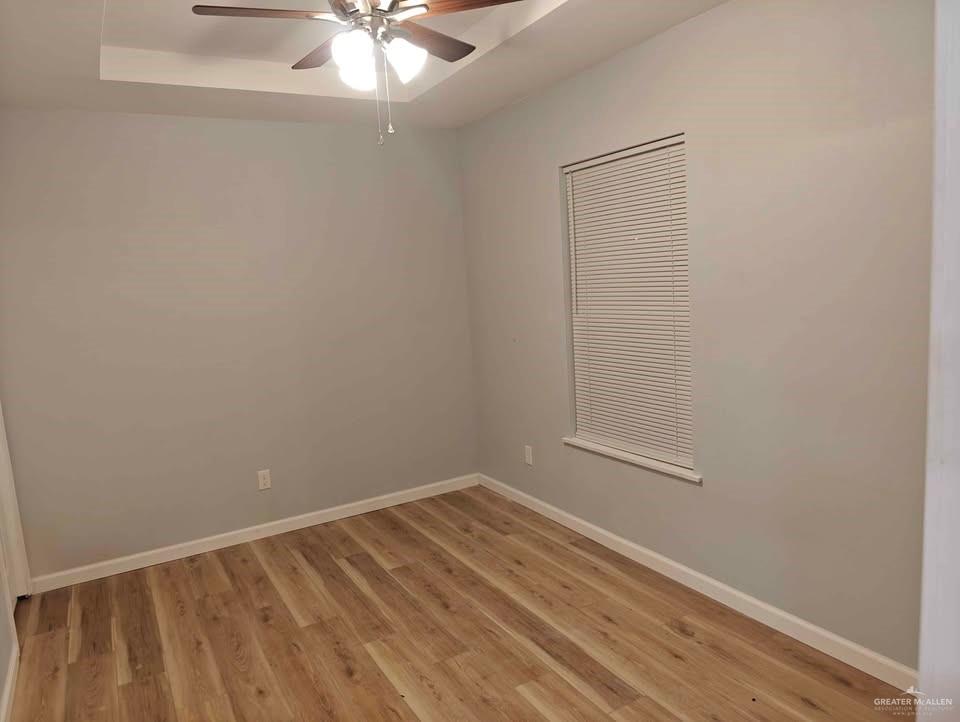 2736 Naples Street Weslaco, TX 78596 - Photo 9 of 14 a view of an empty room with wooden floor and a window