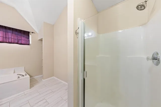 a bathroom with a bathtub and shower