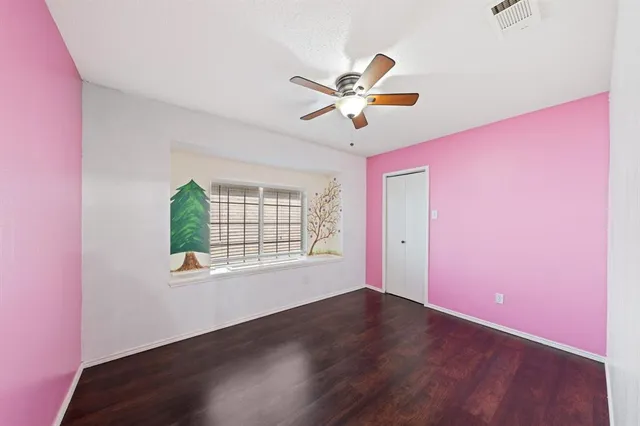 a view of a livingroom with a window and wooden floor